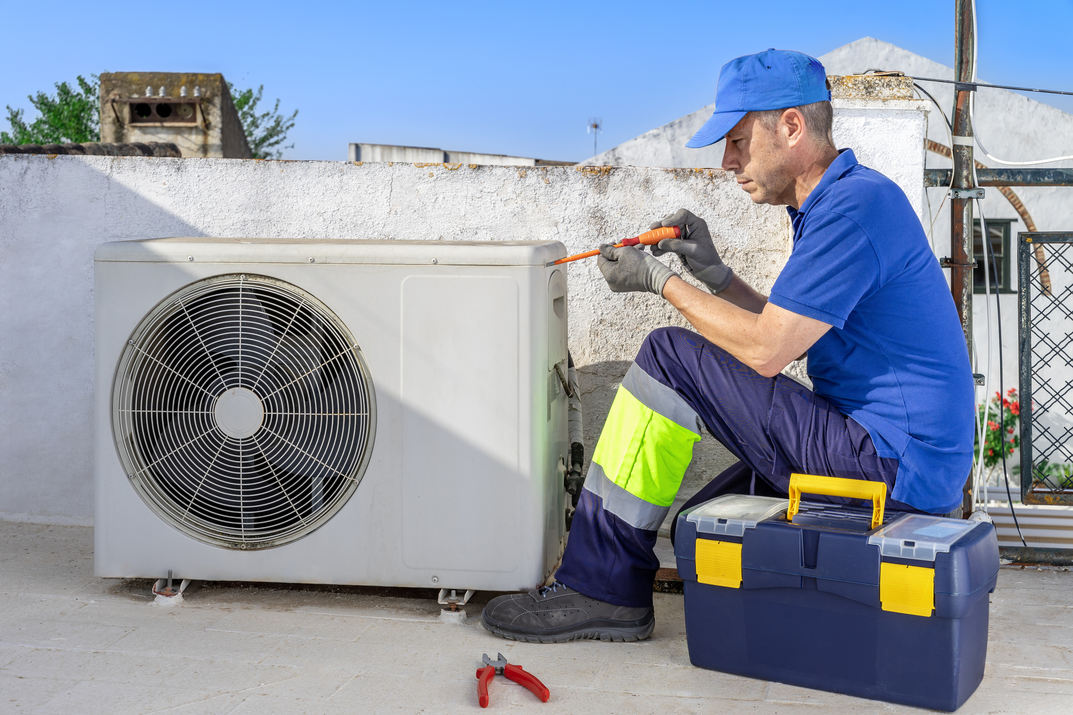 Maintenance technician inspecting an AC unit