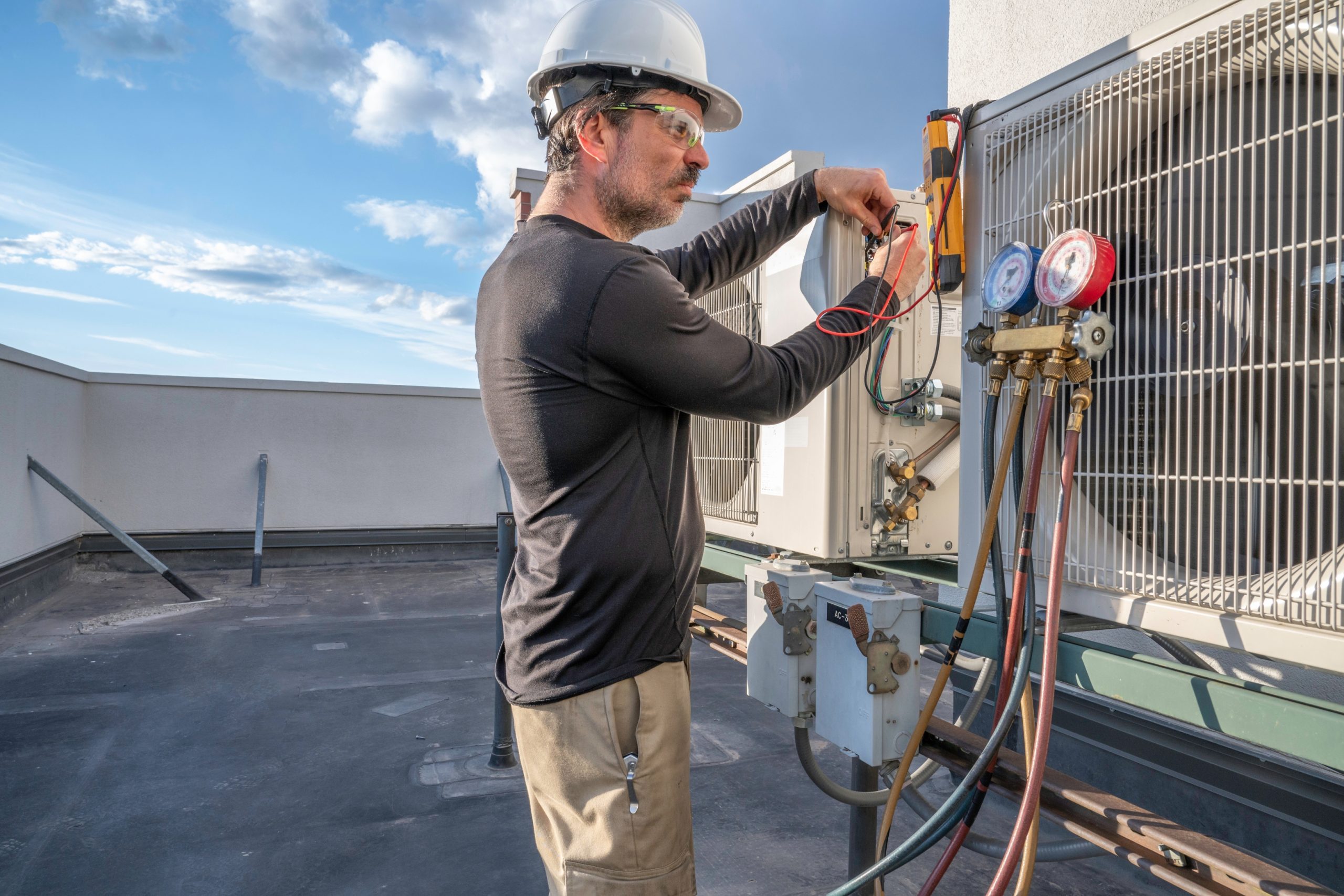 Technician checking VRF refrigerant pressures